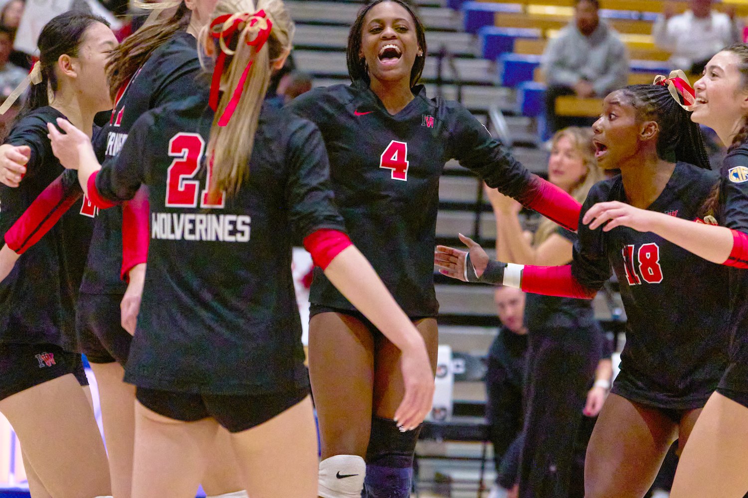 Lauryn Lewis celebrating a point with her Harvard-Westlake teammates on the court.